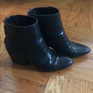 Black snakeskin booties.